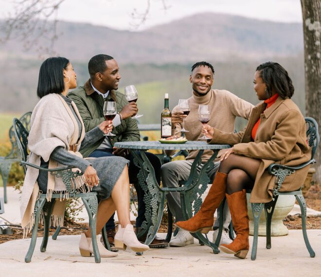 friends drinking wine outdoors during winter