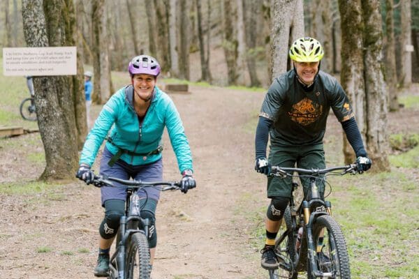 man and woman mountain biking