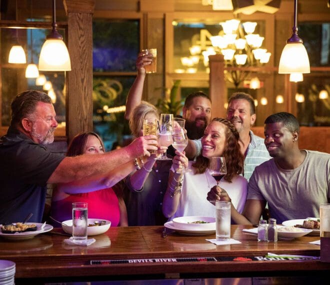 group of friends toasting at Emily's Bar and Restaurant