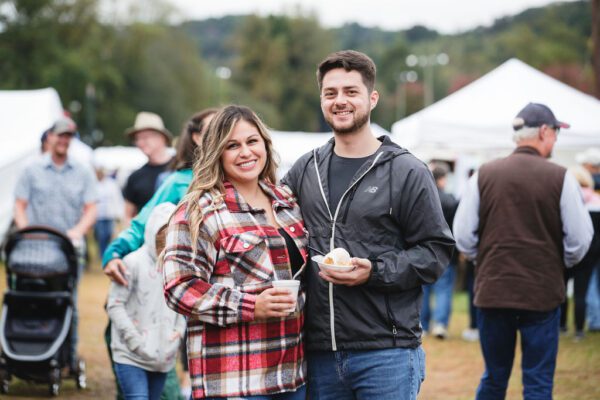 a couple enjoying food at the Apple Festival
