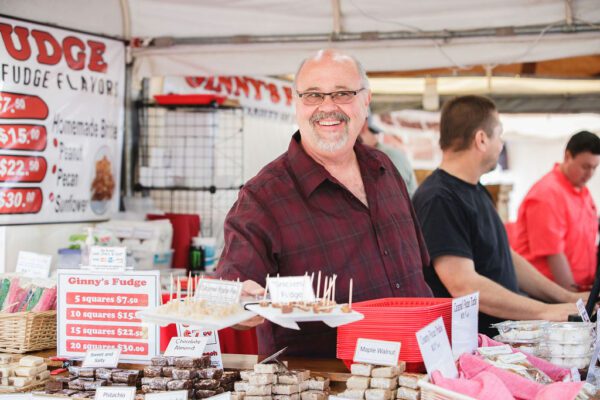 a smiling vendor at the Apple Festival