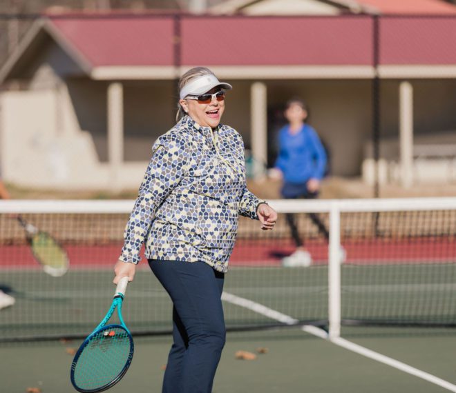 a woman enjoying a round of tennis