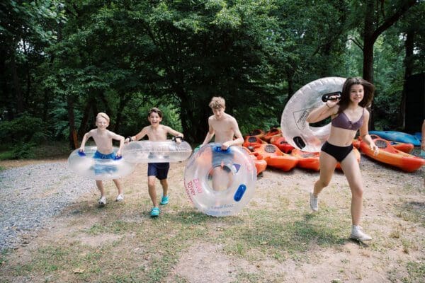kids running with inner tubes