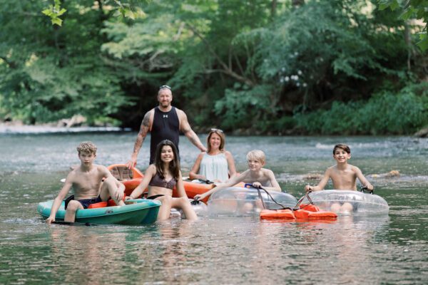 a family tubing and kayaking in the river