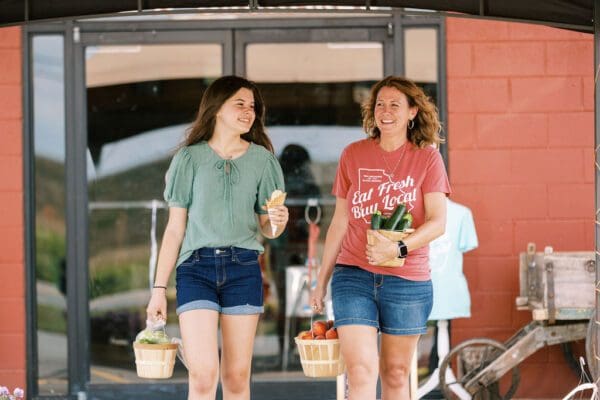 A mom and daughter with icecream and groceries
