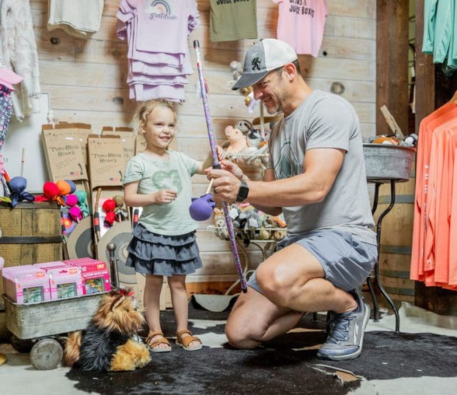 A father showing his daughter a toy
