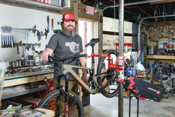a man repairing a bike at Cartecay Bike Shop