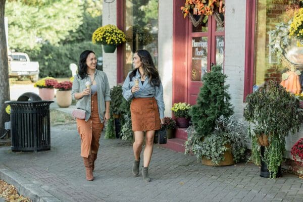 women walking and enjoying ice cream in the fall