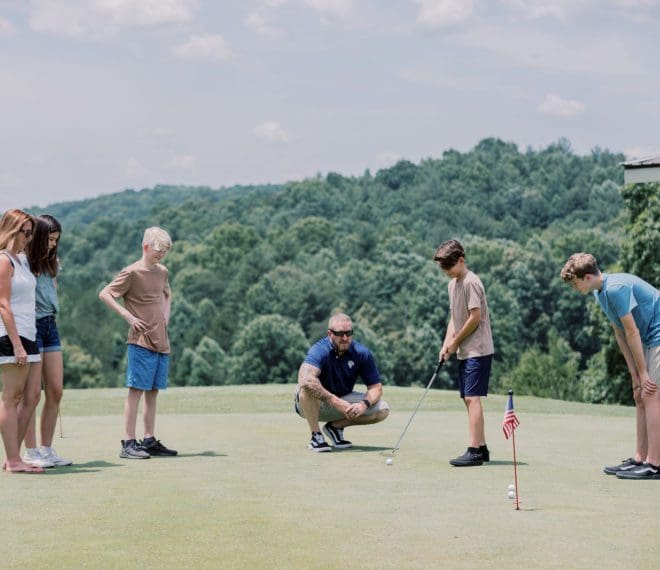 a group of people golfing