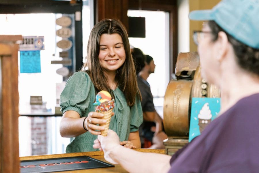 a woman holding an ice-cream cone