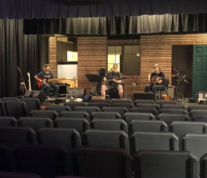 a band playing on stage at the Gilmer Arts Playhouse