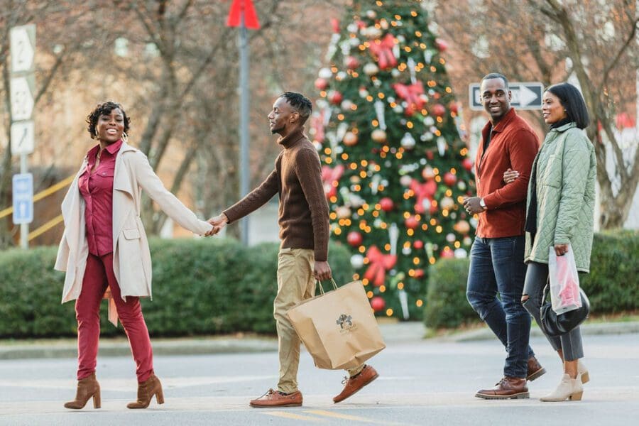 friends walking outside with Christmas decorations