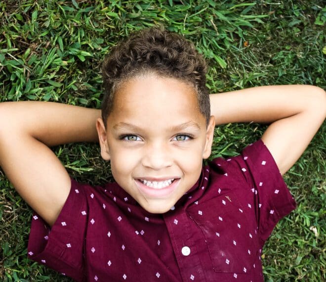 boy laying in grass