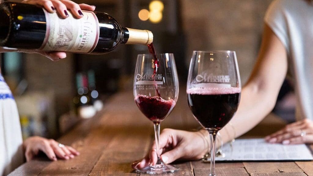 pouring glasses of red wine